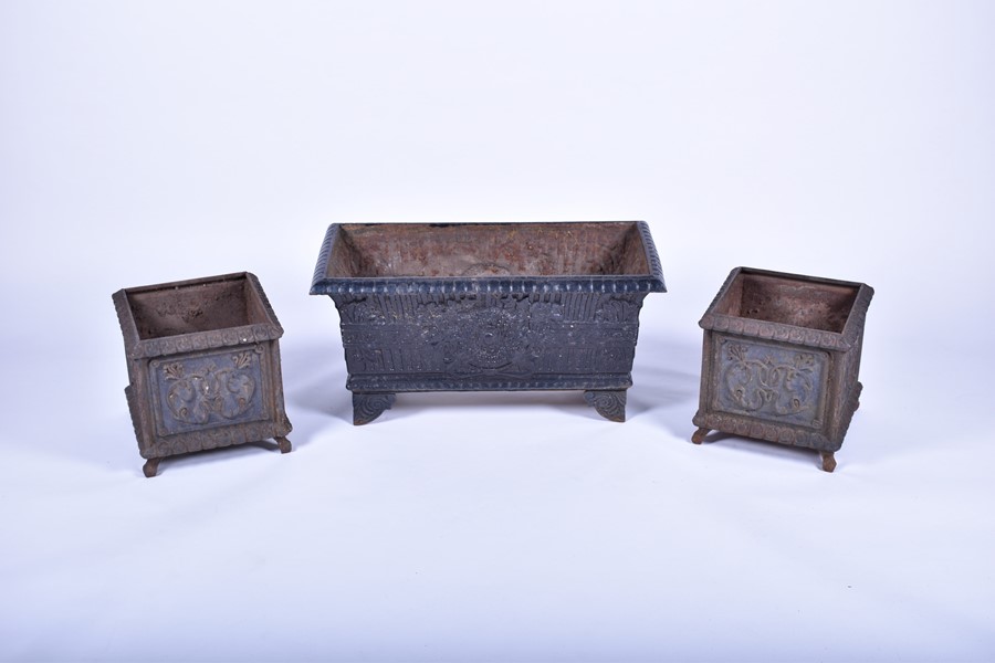 A pair of 20th century cast iron planters of square form with panels of raised foliage motifs and