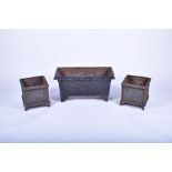 A pair of 20th century cast iron planters of square form with panels of raised foliage motifs and