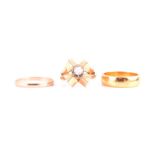 An unusual Modernist style yellow metal and diamond ring the quatrefoil mount centred with a rose-