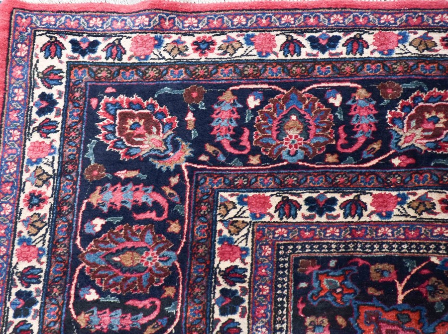 A large Persian Isfahan carpet designed with a red ground central medallion surrounded with shah - Image 2 of 9