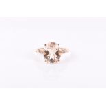 A 9ct yellow gold, diamond, and morganite ring the slender shoulders with twisted decoration and set