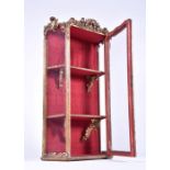 A 19th century Italian gilt gesso glazed display wall cabinet designed with scrolled acanthus