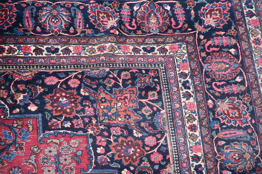 A large Persian Isfahan carpet designed with a red ground central medallion surrounded with shah - Image 3 of 9