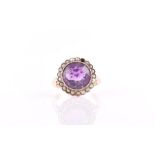 A 9ct yellow gold, amethyst, and split seed pearl ring set with a mixed round-cut amethyst,