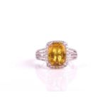 A 14ct white gold, diamond, and yellow sapphire cluster ring set with a rectangular cushion-cut