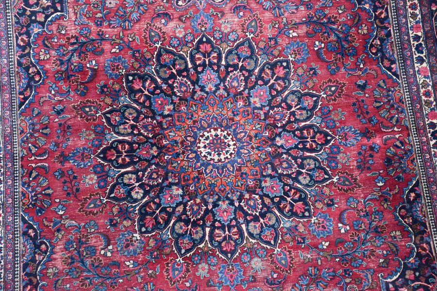 A large Persian Isfahan carpet designed with a red ground central medallion surrounded with shah - Image 4 of 9