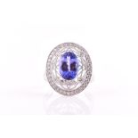 An 18ct white gold, diamond and tanzanite ring set with a mixed oval-cut tanzanite of