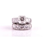 An unusual double band diamond ring one band set with five round brilliant-cut diamonds, the other