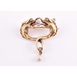 An unusual Art Nouveau yellow gold, diamond, and pearl brooch possibly French, in the form of two