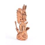 A light wood Balinese carving of a winged demon holding a smaller demon on his shoulders standing