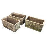 A set of three rectangular cast stoneware garden planters each modelled with raised relief friezes