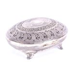 An Eastern white metal potpourri box of oval form, the hinged lid with engraved and pierced