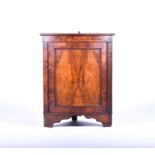 A Victorian walnut floor-standing corner cupboard the single panelled door opening to reveal a