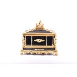 A French Napoleon III ormolu mounted ebonised wooden casket surmounted with a gilt bronze figural