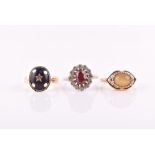 A 10k yellow gold, chrysoberyl and black enamel ring set east to west with a cats eye chrysoberyl,
