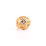 An unusual 18ct yellow gold and diamond floral cluster ring the domed cluster centred with round