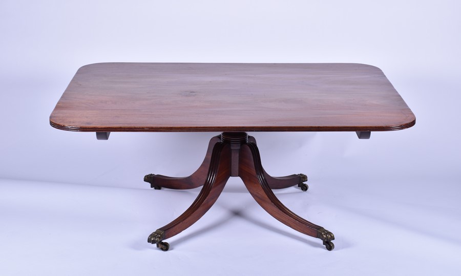 A 19th century mahogany rectangular pedestal low table on converted column and four swept legs,