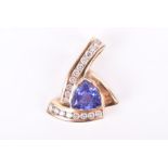 A yellow metal, diamond, and tanzanite pendant of asymmetric form, set with a trillion-cut tanzanite