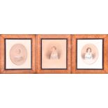 A group of three 19th century watercolour portraits of children with gouache heightening, in maple