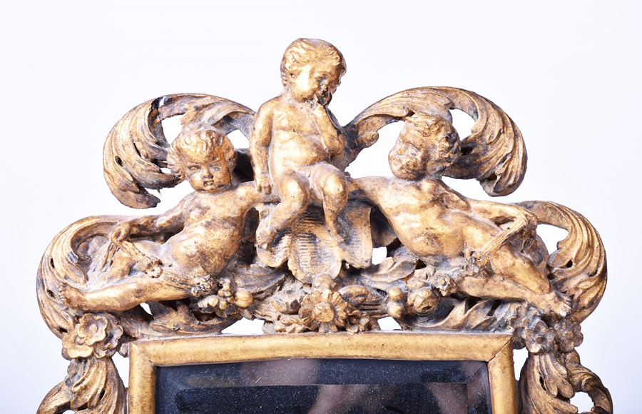 A 19th century style giltwood framed Italian wall mirror modelled with winged and musical cherubs on - Image 2 of 5