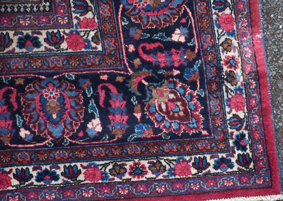 A large Persian Isfahan carpet designed with a red ground central medallion surrounded with shah - Image 6 of 9