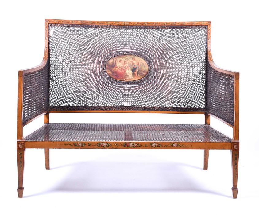 An Edwardian Sheraton Revival painted satinwood bergere settee the central oval panel painted with a - Image 2 of 15