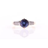 A tanzanite and diamond ring centred with a round mixed-cut tanzanite measuring 7.2 x 7.15 x 4.51