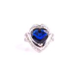 A platinum, diamond and sapphire ring set with a heart-shaped sapphire of approximately 4.0