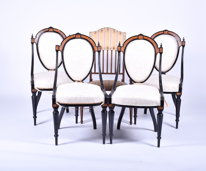 A set of four Victorian style ebonised chairs with gilt embellishment and inlaid burr wood, with