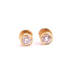 A pair of round brilliant-cut diamond ear studs of approximately 1.0 carat combined, approximate