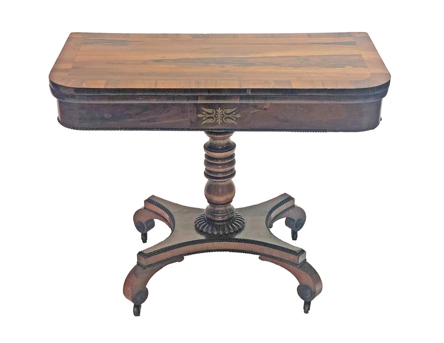 A Regency rosewood card table the top with brass inlay, (later glass cover), with green baize