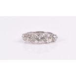 An impressive platinum and diamond ring set with five graduated old-cut diamonds of approximately