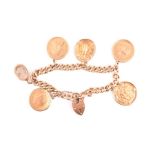 An 18ct yellow gold curb-link bracelet suspended with various coins, including a 1965 Kruggerand,