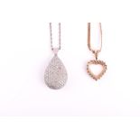 A silver gilt and clear stone heart-shaped pendant suspended on a 9ct yellow gold flat-link chain,