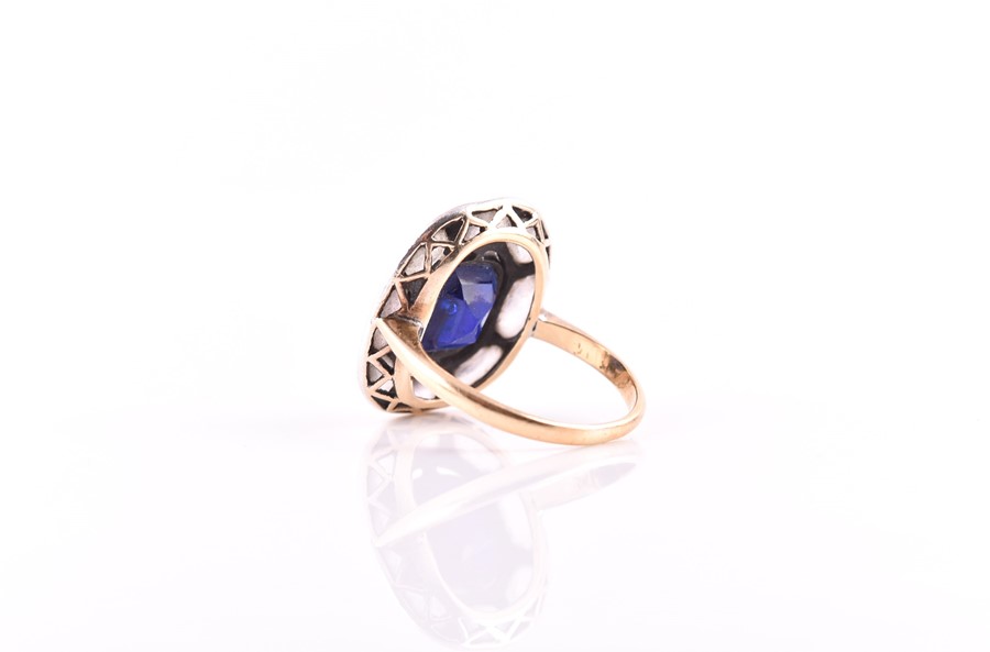 An early to mid 20th century yellow metal and paste stone ring set with a blue paste stone within - Image 2 of 4