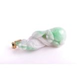 An unusual Chinese carved natural jade pendant in the form of a dragon on a lotus flower,