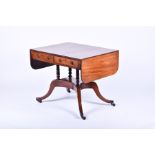 A Regency mahogany sofa table  with two drawers opposed by two dummy drawers, on turned columns