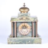 A Victorian gilt metal mounted onyx mantel clock the central brass movement with Roman numerals,