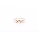 A yellow metal and pearl ring (unmarked yellow gold) set with three individually set pearls,