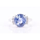 A platinum, diamond, and sapphire ring set with a mixed oval-cut sapphire of approximately 4.60