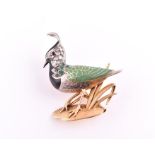 Alopa. An unusual yellow gold, diamond and gemstone bird brooch in the form of a lapwing, the head