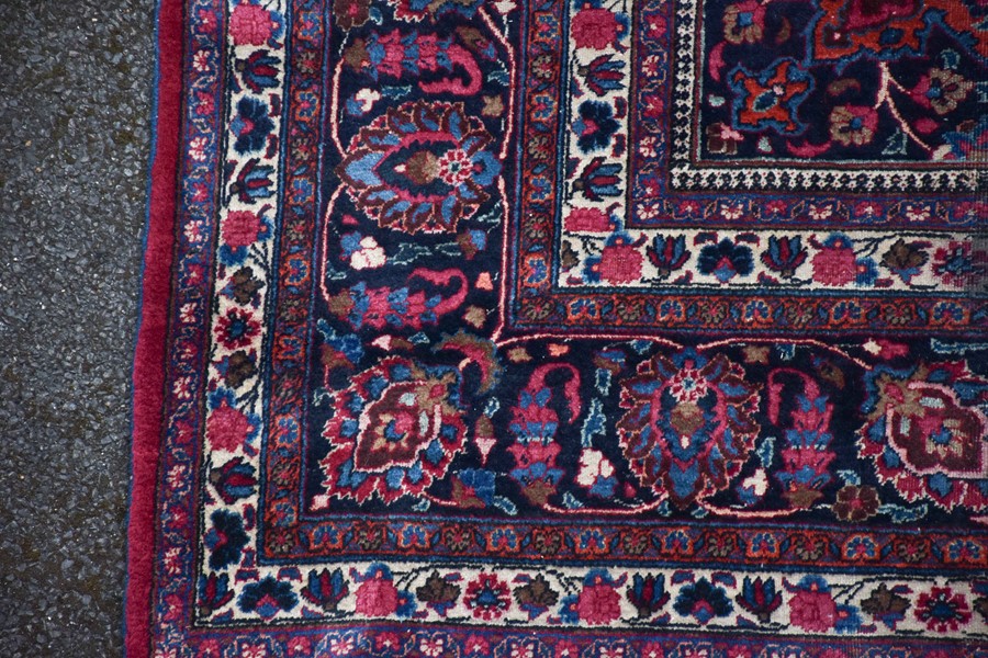 A large Persian Isfahan carpet designed with a red ground central medallion surrounded with shah - Image 5 of 9