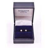 A pair of solitaire diamond ear studs of approximately 0.30 carats combined, screw stud backs,