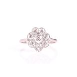 A diamond daisy cluster ring set with eight round brilliant-cut diamonds, approximate colour and