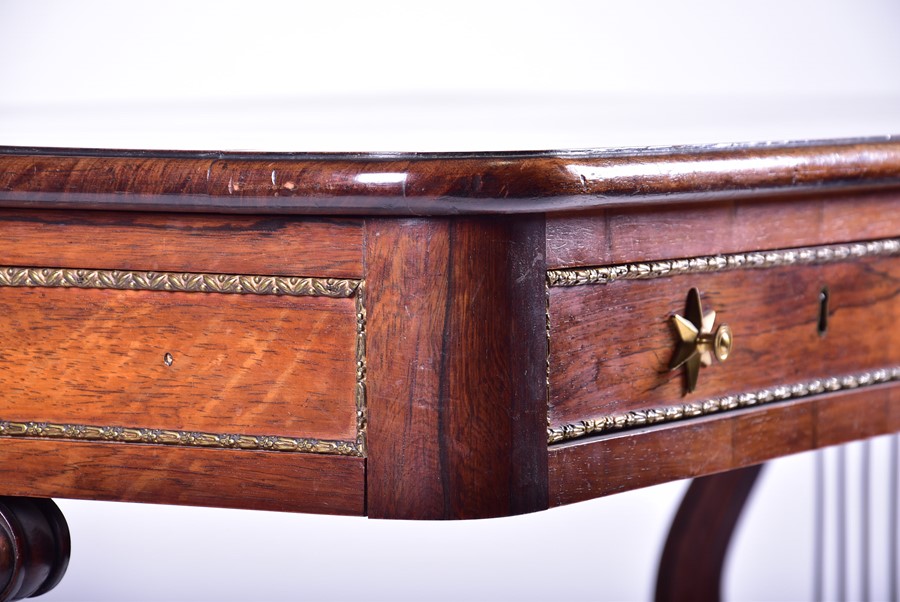 A Regency rosewood and brass mounted lyre end library table in the manner of Gillows, with four - Image 6 of 8