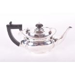 An early 20th century silver bachelors tea pot Chester 1913, the plain body is decorated with chased