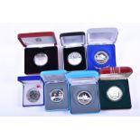 A collection of seven boxed silver proof sporting commemorative coins comprising two 2006