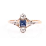 An early 20th century 18ct yellow gold, diamond, and sapphire ring in the Art Deco style, centred