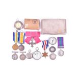 A group of militaria and medals comprising a group of WWI medals and WWII medals, a female MBE