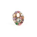 An unusual yellow gold and multi-gem ring the oval mount inset with mixed-cut semi-precious and
